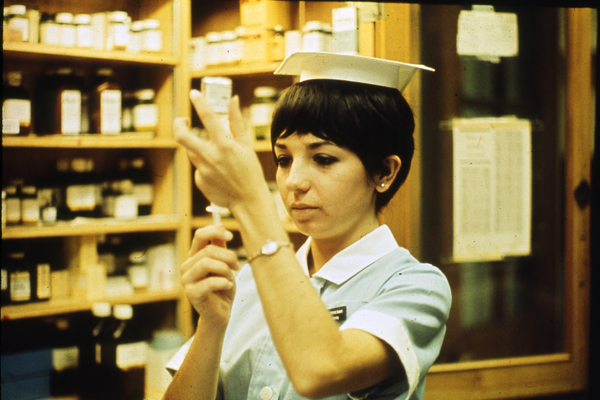 Vintage photo of nurse holding up a vaccination needle