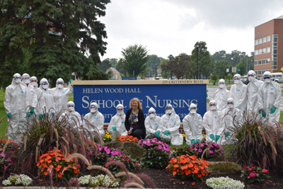 High school students participating in the pre-college program in nursing at the University of Rochester pose in their surgical gowns with Assistant Professor of Clinical Nursing Kathy Hiltunen.