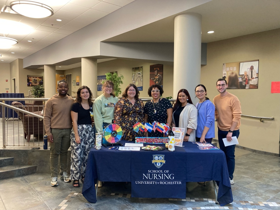 Group photo of the CoDEI and Student Affairs teams at a Hispanic Heritage Month table. 