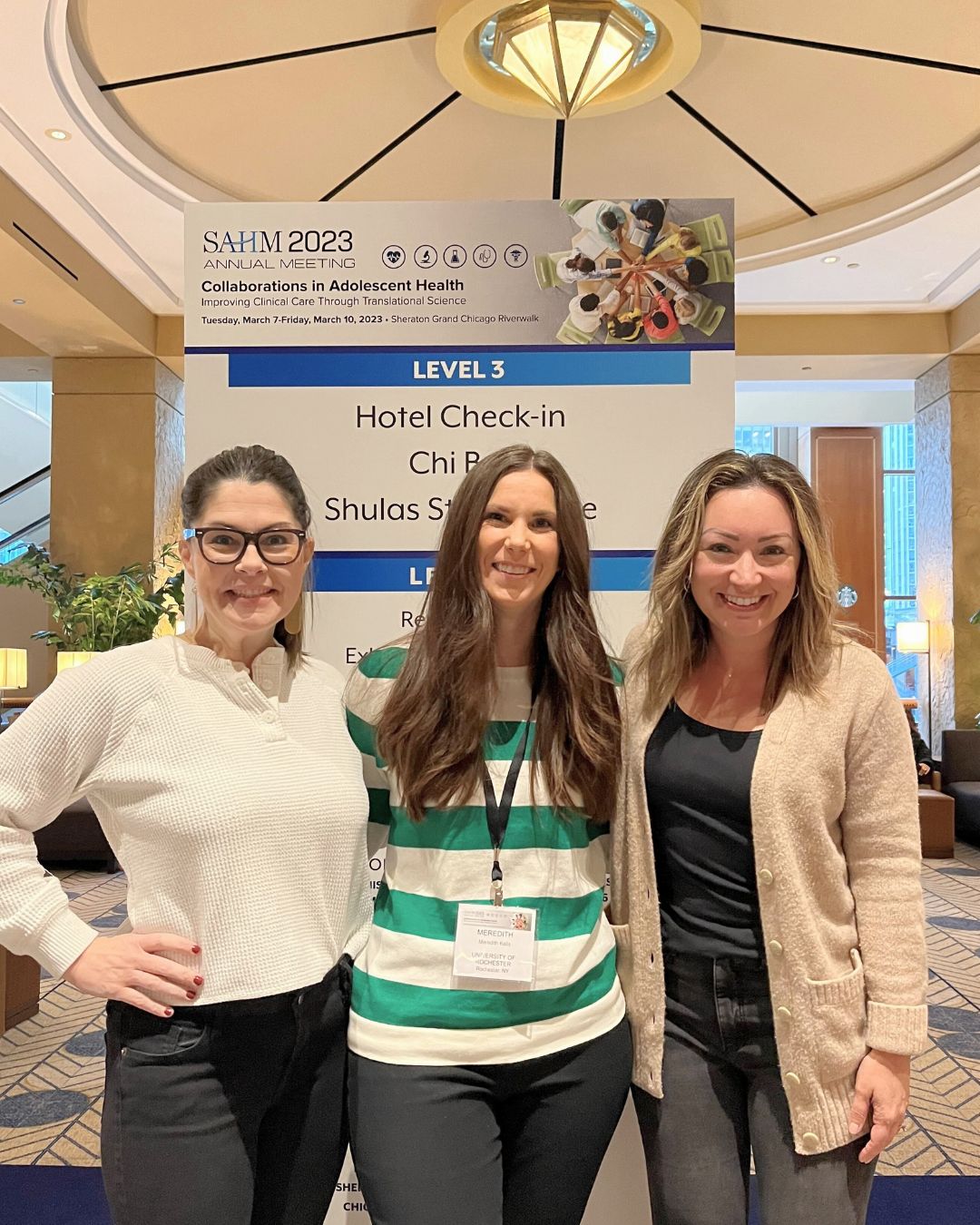 Amy Realbuto, Meredith Kells, and Heather Wensley pose for a photo together at the 2024 Society for Adolescent Health and Medicine conference.