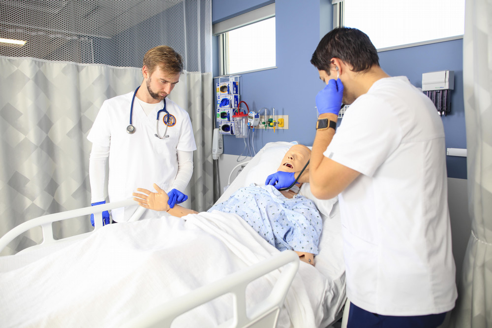 Accelerated Nursing Students working with a manikin.