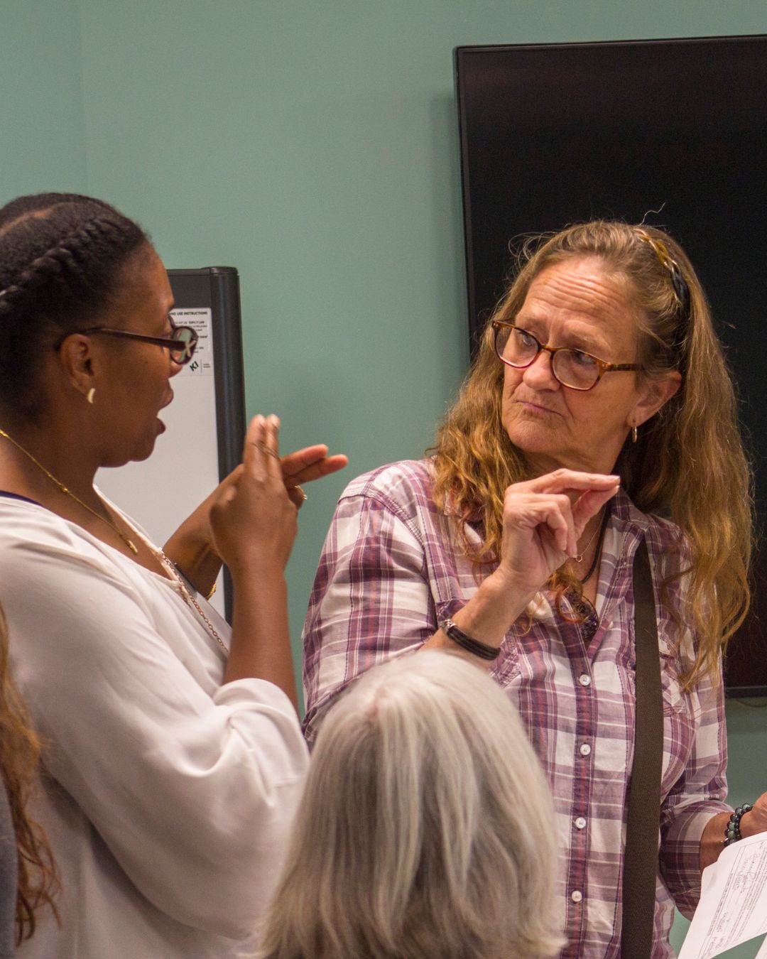 Photo of Tamala and a colleague using Sign Language