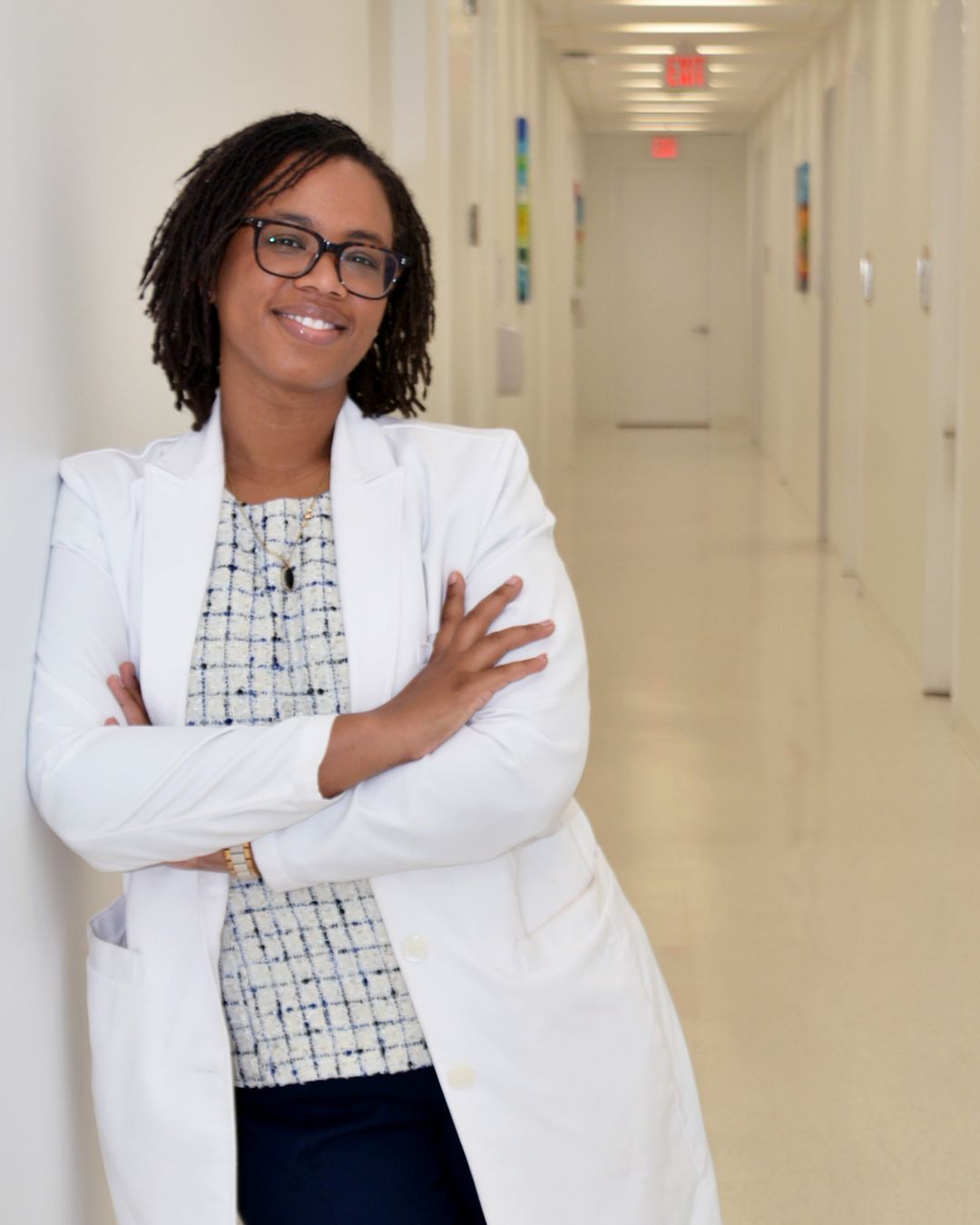 Arnice Jackson in a white lab coat, standing in a hallway