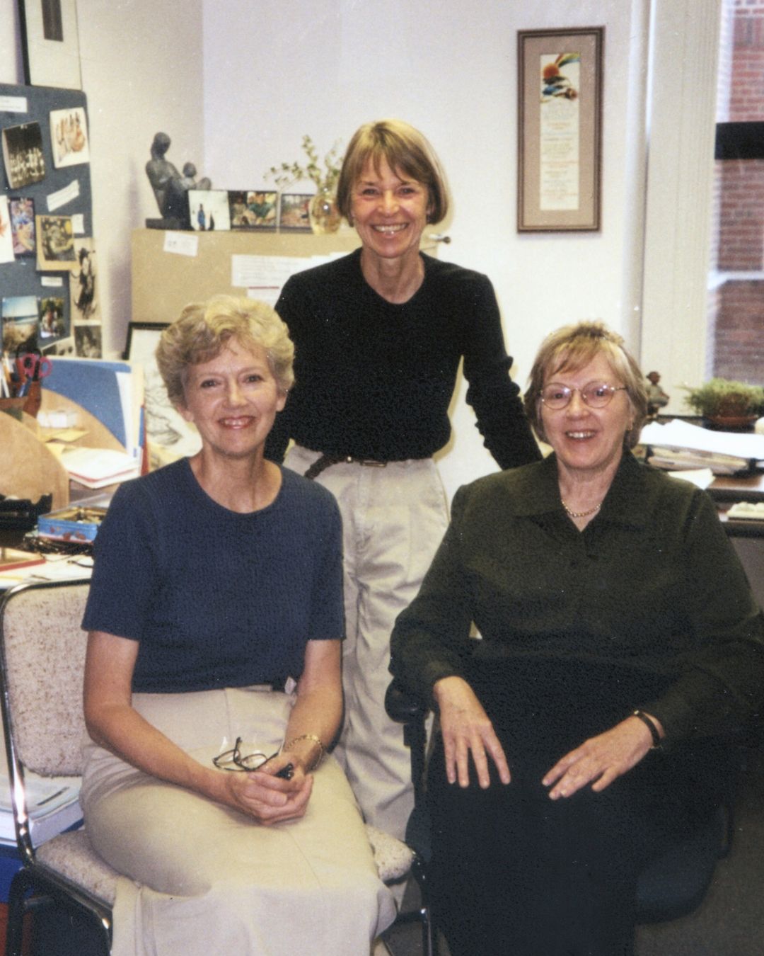 Lorrie Yoos, Harriet Kitzman, and Ann McMullen smile in an office.